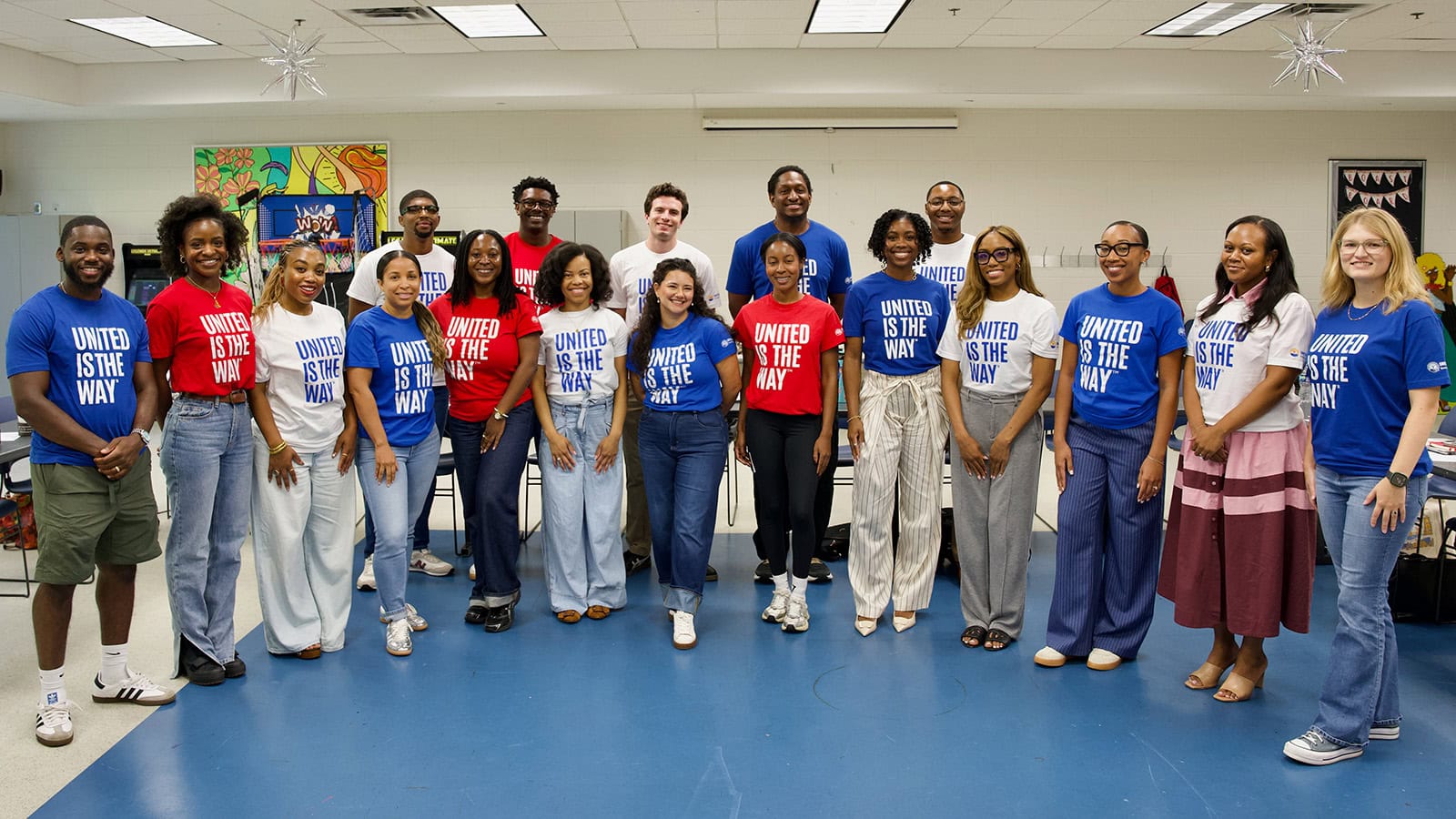 A group of young professionals pose in a classroom