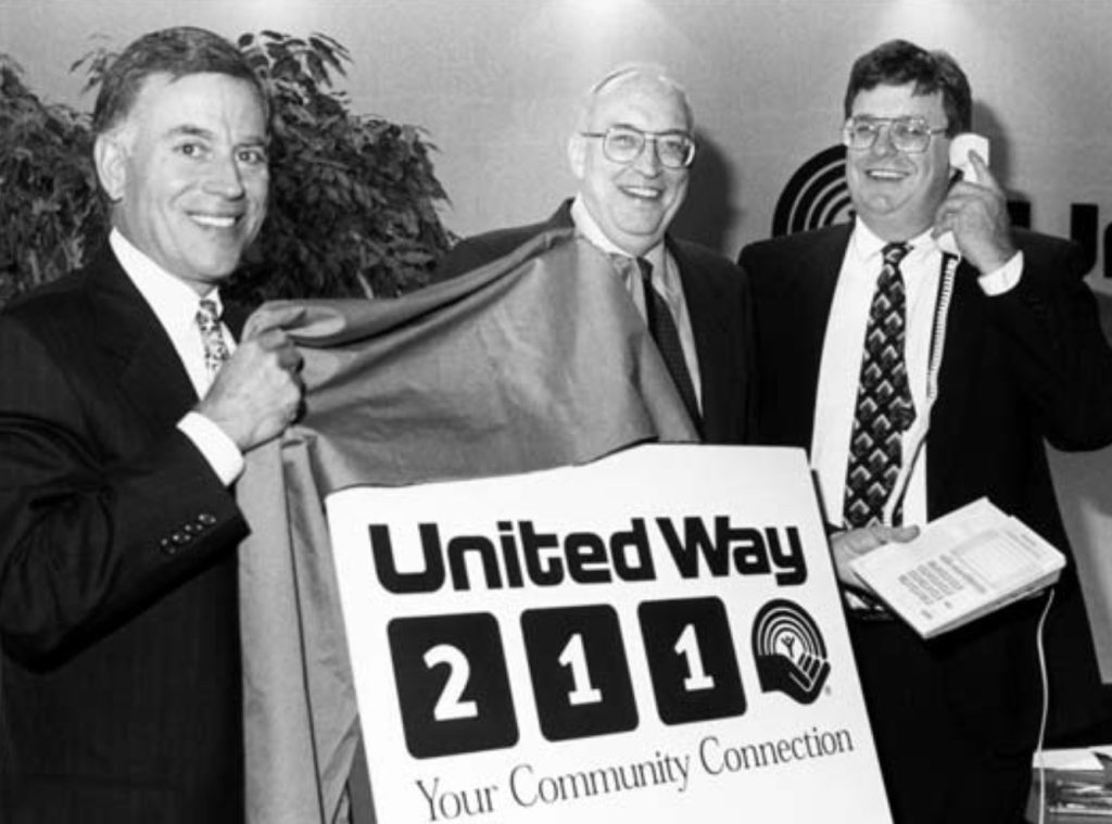 United Way president Mark O’Connell, then United Way board chair Kent C. “Oz” Nelson, and former chairman of the Georgia Public Service Commission Stan Wise dial 211 for the first time on June 12, 1997