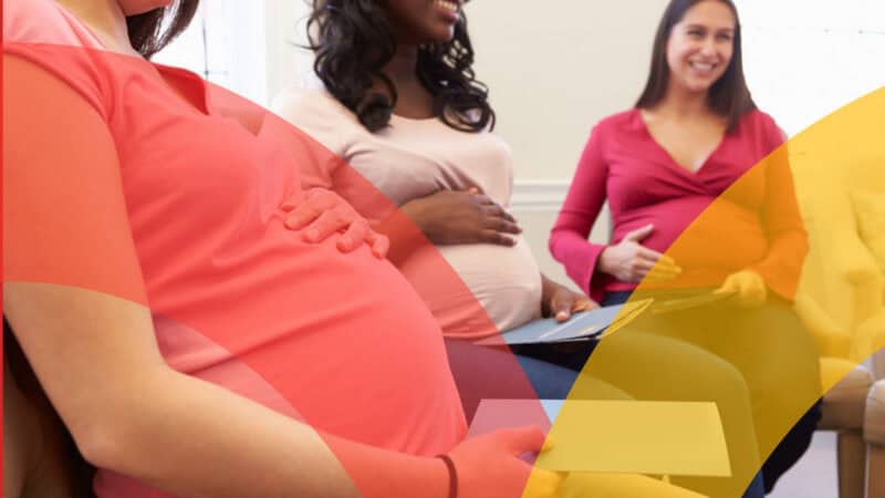 Pregnant Women in a class.Focus on belly