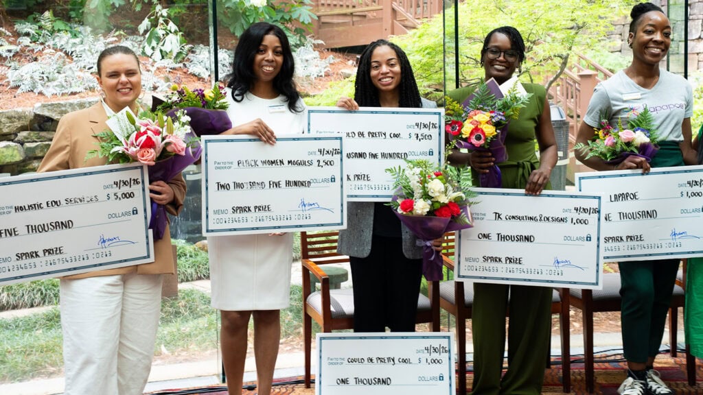 Women entrepreneurs pose with SPARK prize winnings during Small Business Month