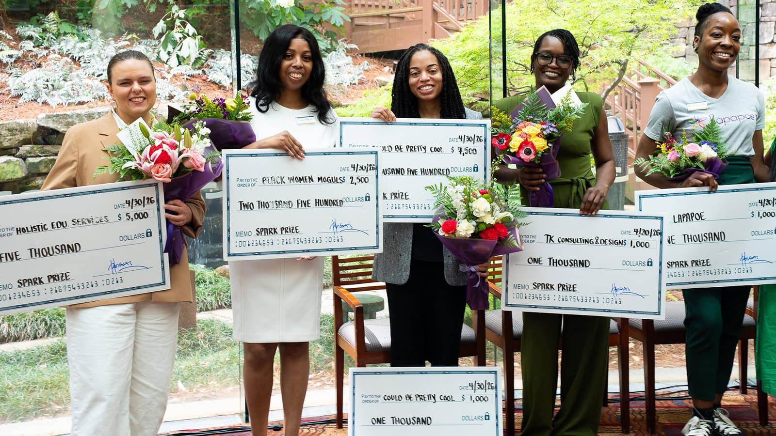 Women entrepreneurs pose with SPARK prize winnings during Small Business Month