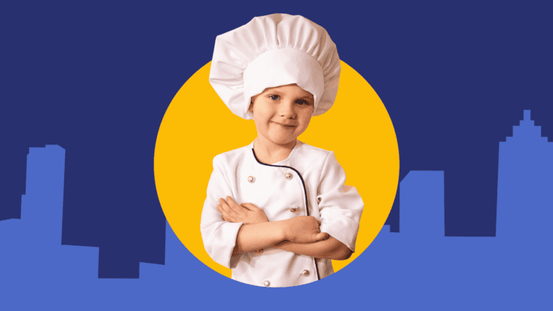 Child chef poses against United Way backdrop
