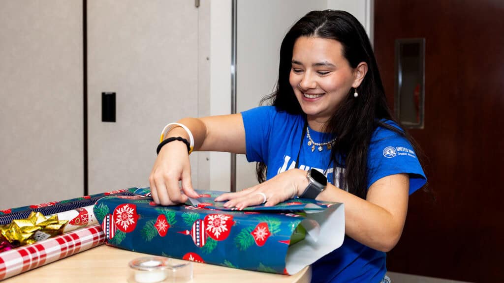United Way of Greater Atlanta volunteer wrapping gifts for those in need
